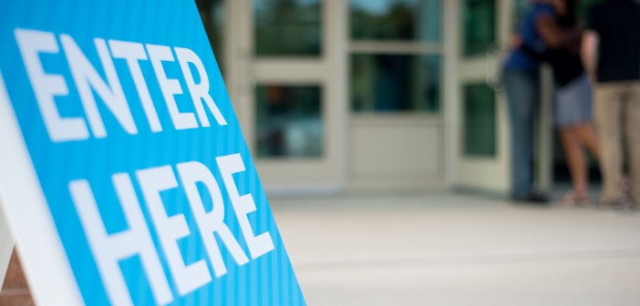 Stock photo of a sign that says "ENTER HERE"