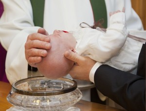 Stock photo of a baby being baptized