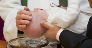 Stock photo of a baby being baptized
