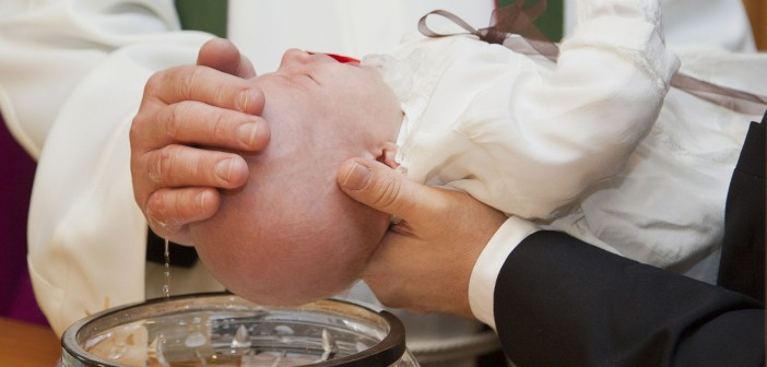 Stock photo of a baby being baptized