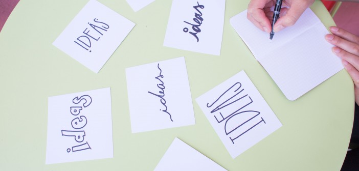 Stock photo of someone writing "IDEAS" on a bunch of different index cards