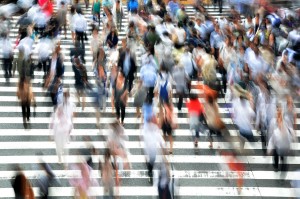 Blurry stock photo of a crowd of people in a crosswalk
