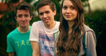 Stock photo of three white youth - two boys and one girl- outside