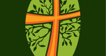 Clip art of an orange cross with green leaves coming out from it