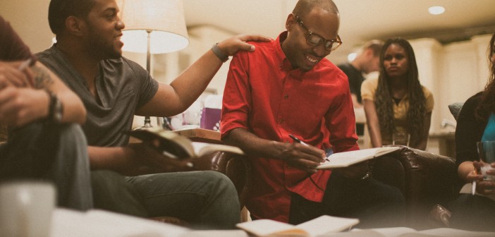 Stock photo of a group of young African Americans hanging out in a lounge