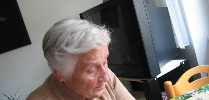 Stock photo of an elderly white man sitting at a table