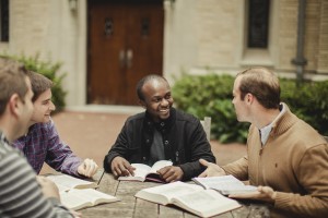 Stock photo of a small, mixed race group of younger men in bible study