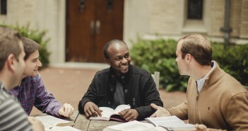 Stock photo of a small, mixed race group of younger men in bible study