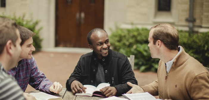 Stock photo of a small, mixed race group of younger men in bible study