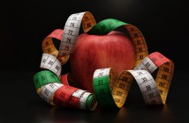 Photo of an apple draped with a measuring tape