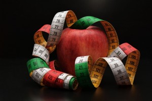 Photo of an apple draped with a measuring tape