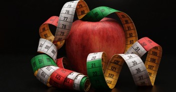 Photo of an apple draped with a measuring tape