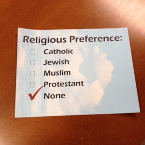 Stock photo of a religious preference form with the options: Catholic, Jewish, Muslim, Protestant, and None. None is checked off.