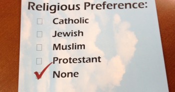 Stock photo of a religious preference form with the options: Catholic, Jewish, Muslim, Protestant, and None. None is checked off.
