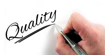 Stock photo of someone writing "Quality" in cursive letters