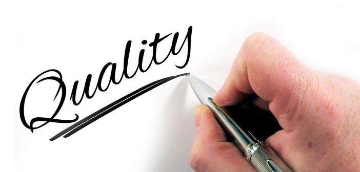 Stock photo of someone writing "Quality" in cursive letters