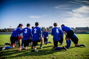 Stock photo of a group of young male soccer players in a huddle