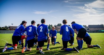 Stock photo of a group of young male soccer players in a huddle