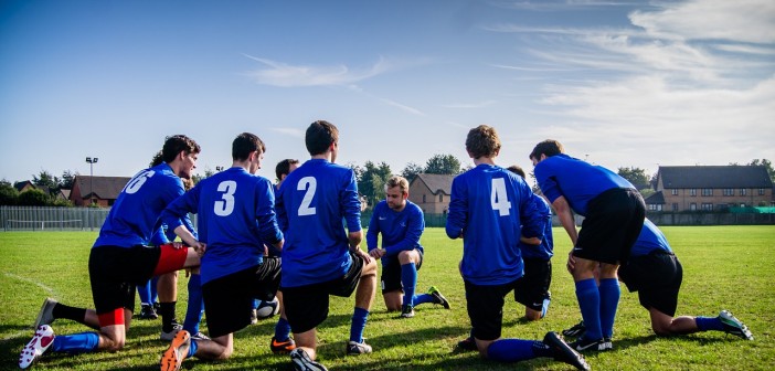 Stock photo of a group of young male soccer players in a huddle