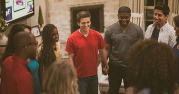 Smiling people in a ministry group holding hands in a circle