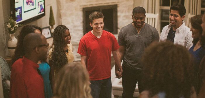 Smiling people in a ministry group holding hands in a circle