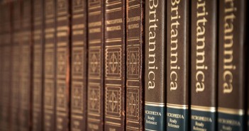 Stock photo of a reference stack at a library featuring different volumes and editions of Encyclopedia Britannica