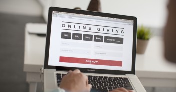Stock photo of someone on their MacBook Pro on a website for online giving