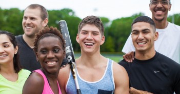 Stock photo of a mixed gender and mixed race group of young people after a pickup baseball or softball game