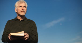 Stock photo of a middle-aged white man squinting outside on a beautiful day