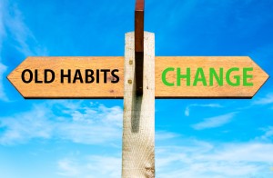 Stock photo of sign post with "OLD HABITS" in one direction and "CHANGE" in the other