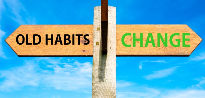 Stock photo of sign post with "OLD HABITS" in one direction and "CHANGE" in the other