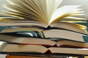 Stock photo of a stack of books that are opened and piled on top of each other