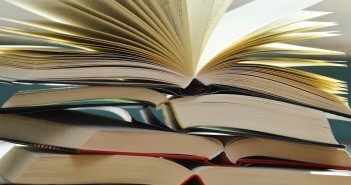 Stock photo of a stack of books that are opened and piled on top of each other