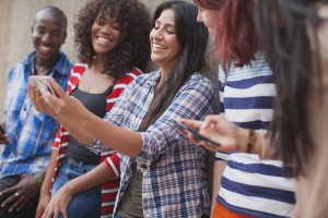 Stock photo of a mixed gender and mixed race group of young adults taking a selfie