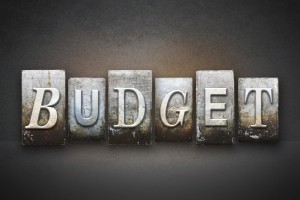 Stock photo of Six metal stamps with letters on each of them that spell out "BUDGET"