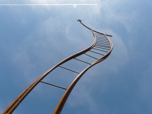 Stock photo of a bendy ladder going towards the sky