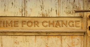 Stock photo of a door with the words "TIME FOR CHANGE" carved into it