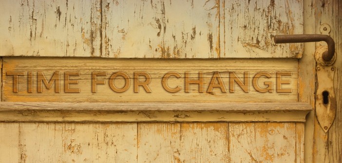 Stock photo of a door with the words "TIME FOR CHANGE" carved into it