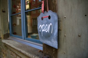 Stock photo of a chalk sign that says "open" in a cursive script