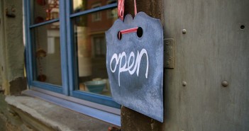 Stock photo of a chalk sign that says "open" in a cursive script