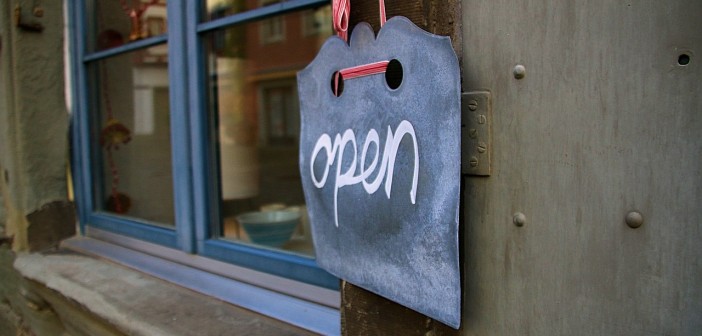 Stock photo of a chalk sign that says "open" in a cursive script