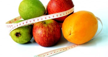 Stock photo of a pile of fruit with a measuring tape wrapped around them