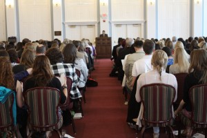Stock photo of a group of people in worship listening to a sermon