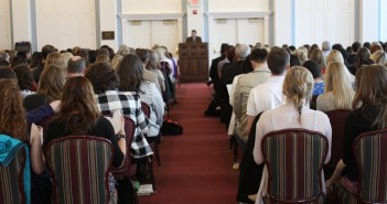 Stock photo of a group of people in worship listening to a sermon