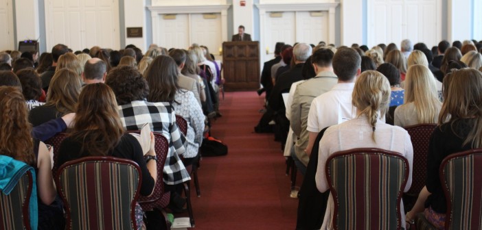 Stock photo of a group of people in worship listening to a sermon