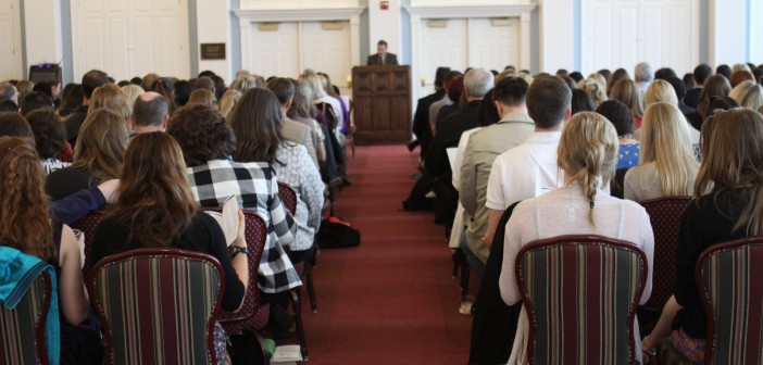 Stock photo of a group of people in worship listening to a sermon