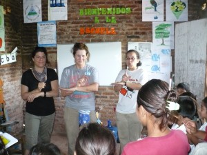 Stock photo of three young women helping lead a vacation bible school on an international mission trip