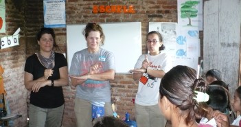 Stock photo of three young women helping lead a vacation bible school on an international mission trip