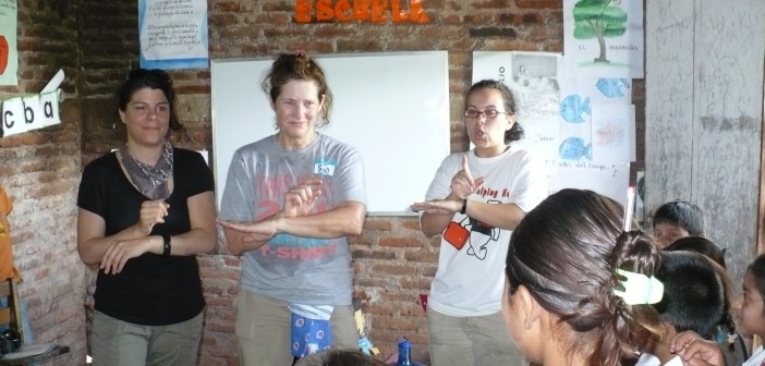 Stock photo of three young women helping lead a vacation bible school on an international mission trip