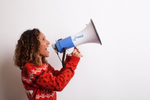 Photo of a woman shouting into a megaphone